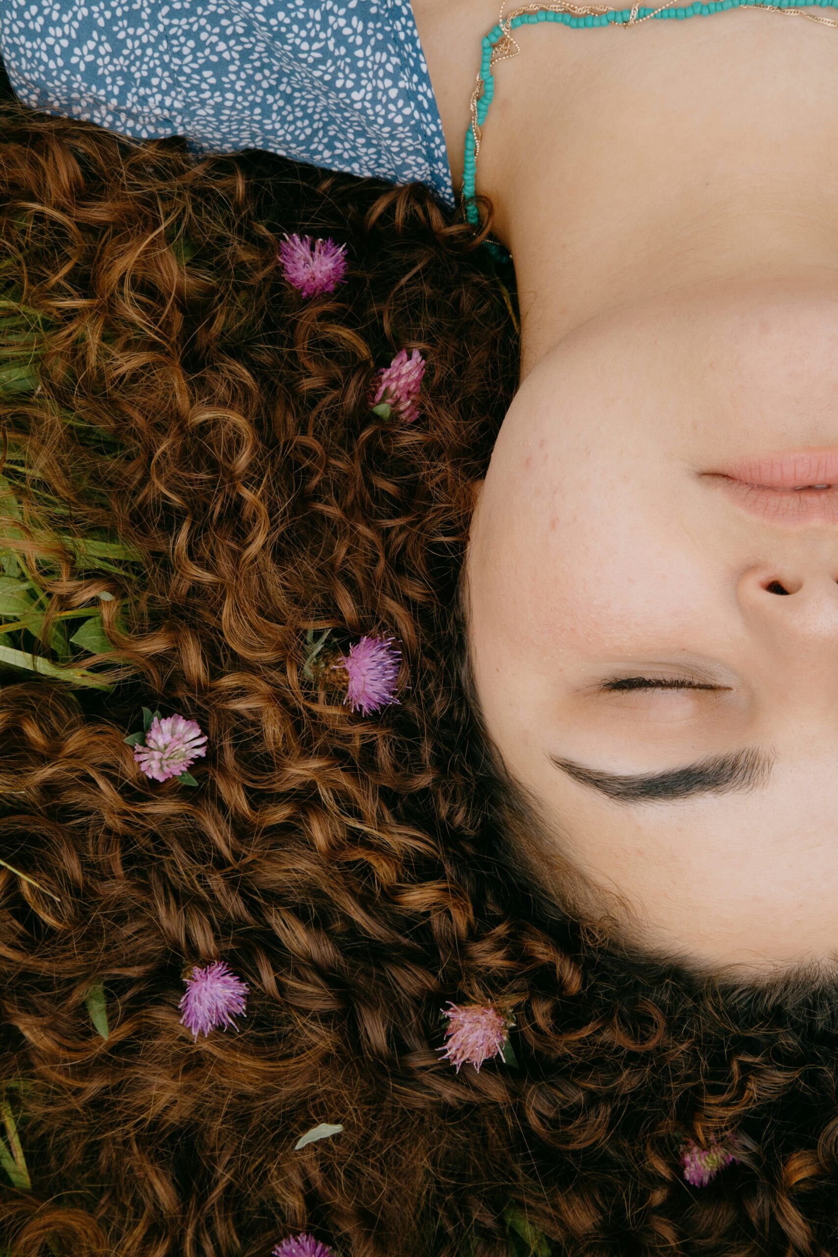 girl lying down with flowers in her hair